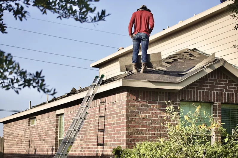 Professional roofer working on a residential roof in Penn Wynne